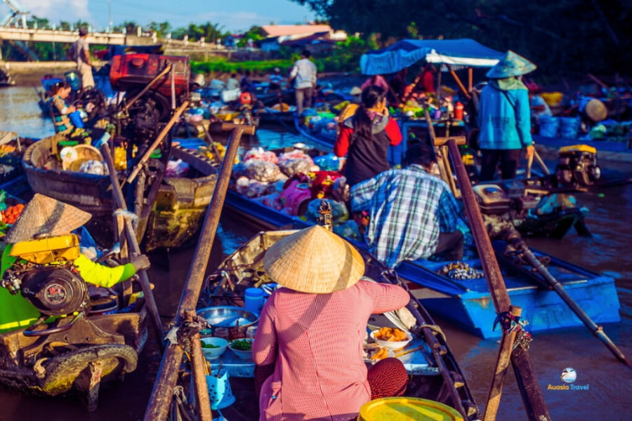 Busy floating market with vendors selling goods on boats in Mekong Delta – Auasia Travel